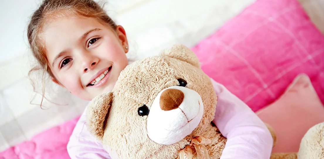 Girl holding prayerbear