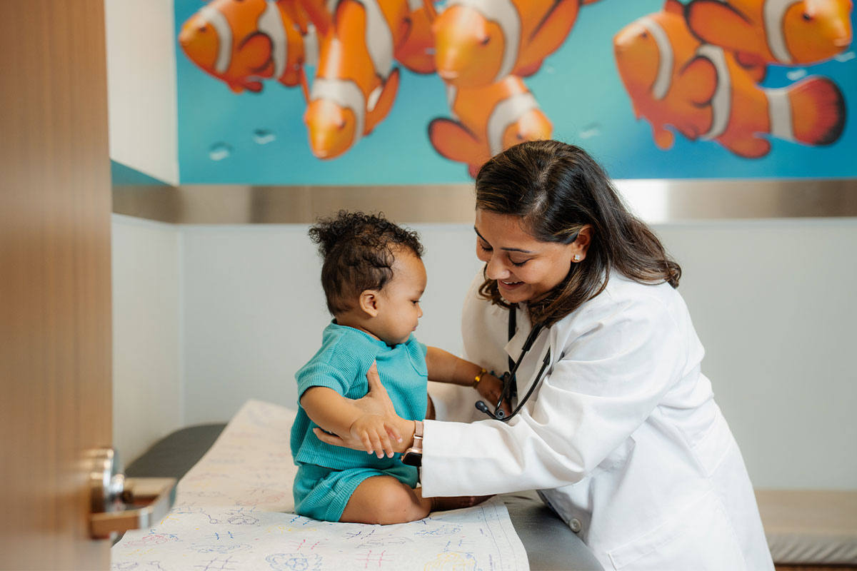Pediatric physician examining a young child’s heart at a pediatric primary care office