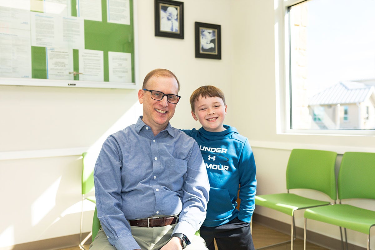 Dr. Seth Kaplan with boy in blue shirt