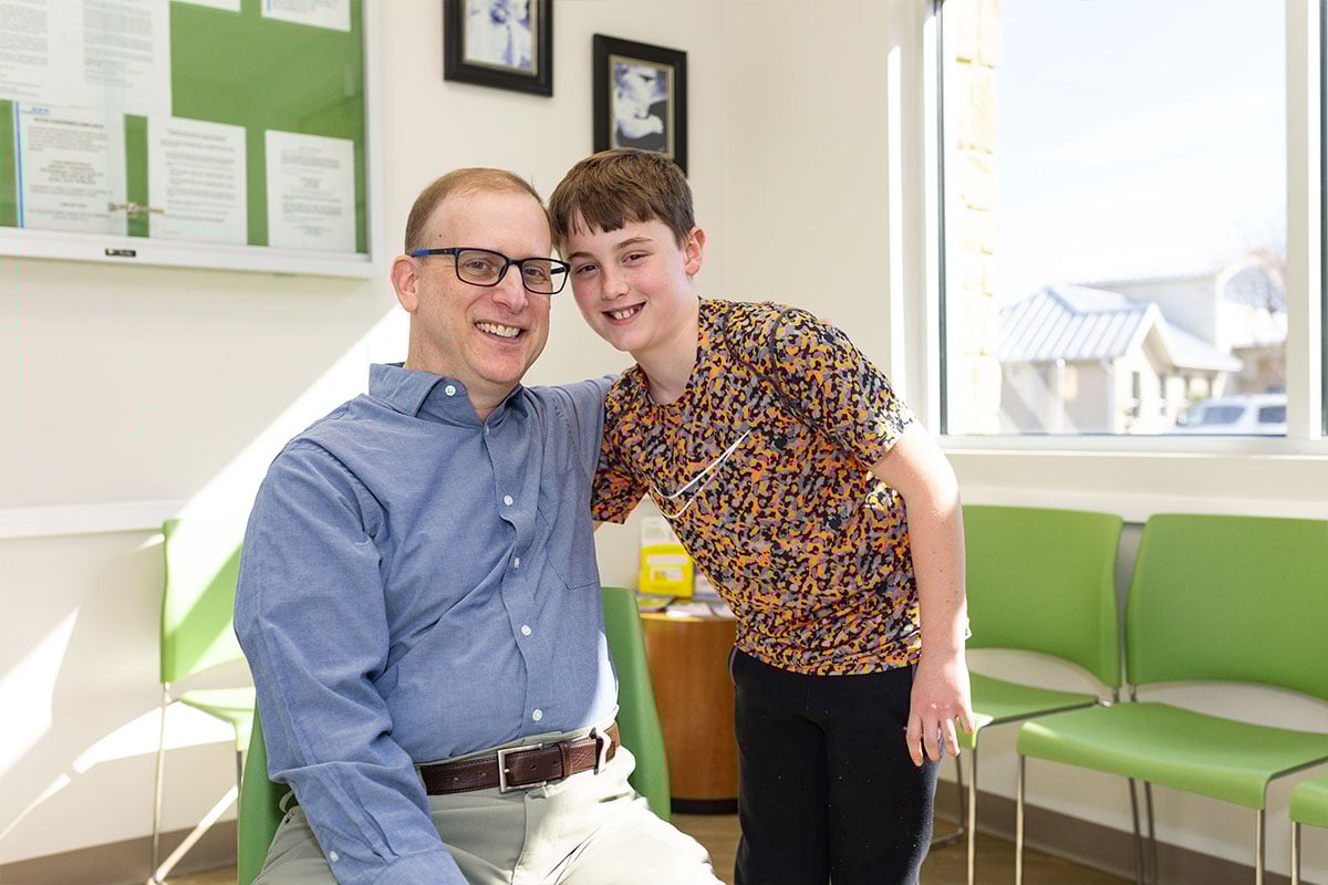 Dr. Kaplan with Boy orange shirt