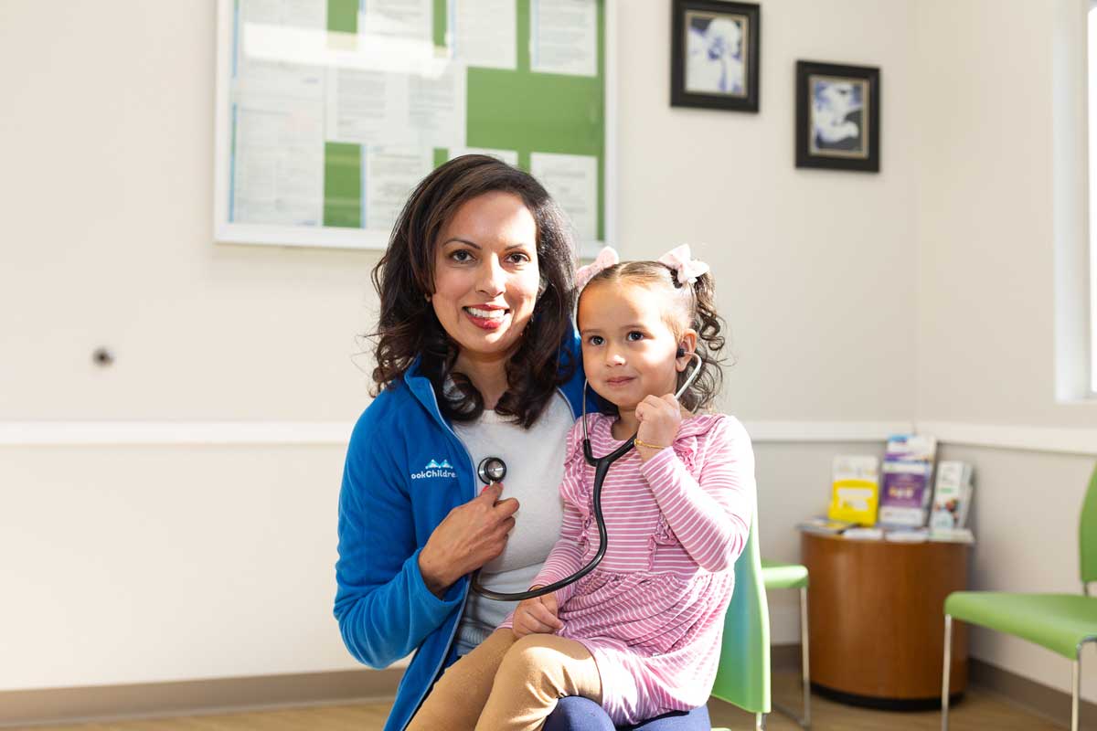 Dr. Bhavana Babber giving stethoscope to girl