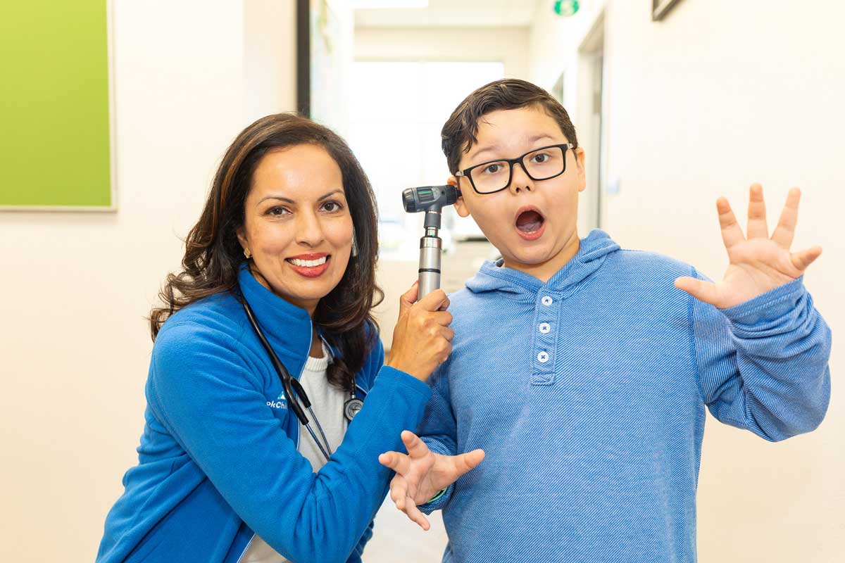 Dr. Bhavana Babber giving ear exam to boy