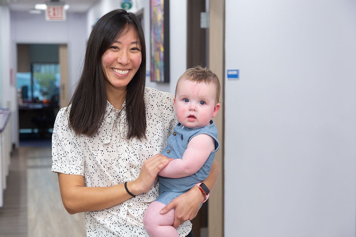 Dr. Hsu carrying Baby