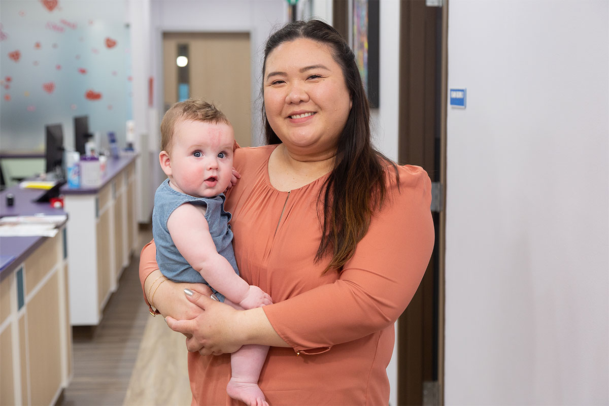 Dr. Nguyen carrying Baby