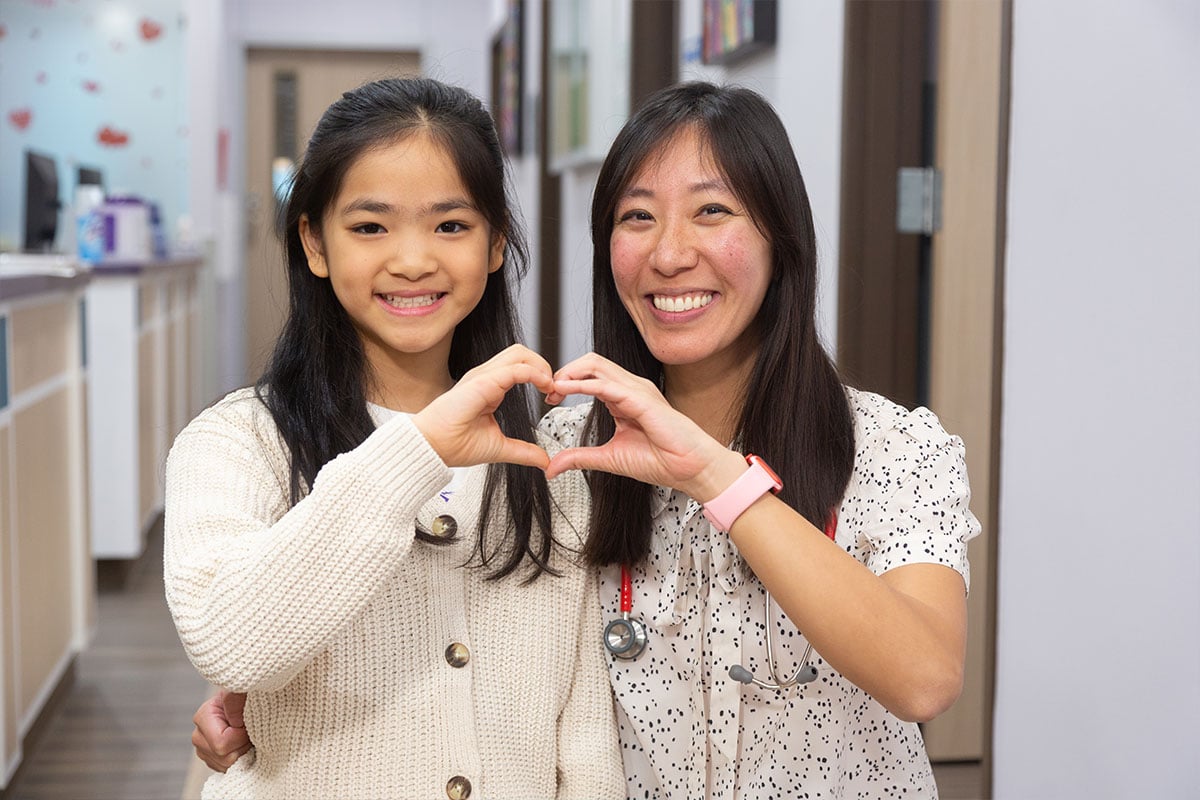 Dr. Hsu making heart with Girl