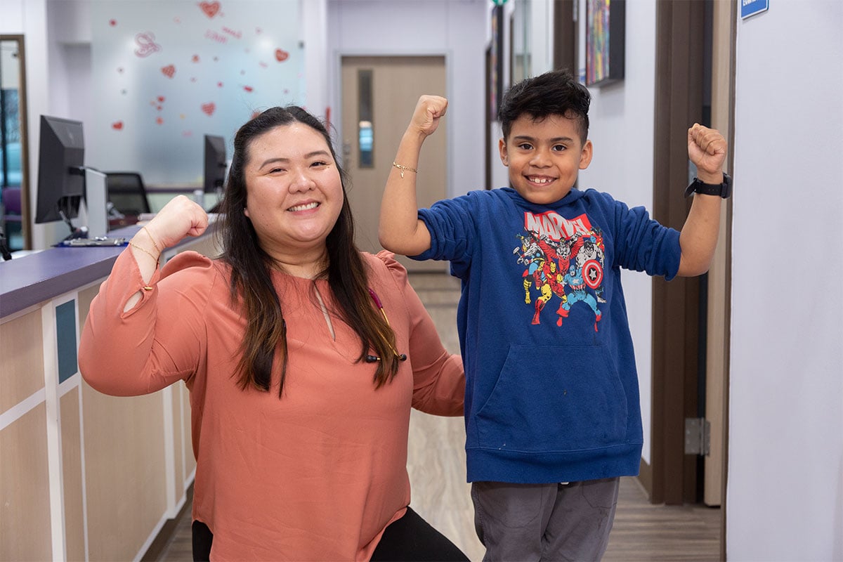 Dr. Nguyen flexing with boy