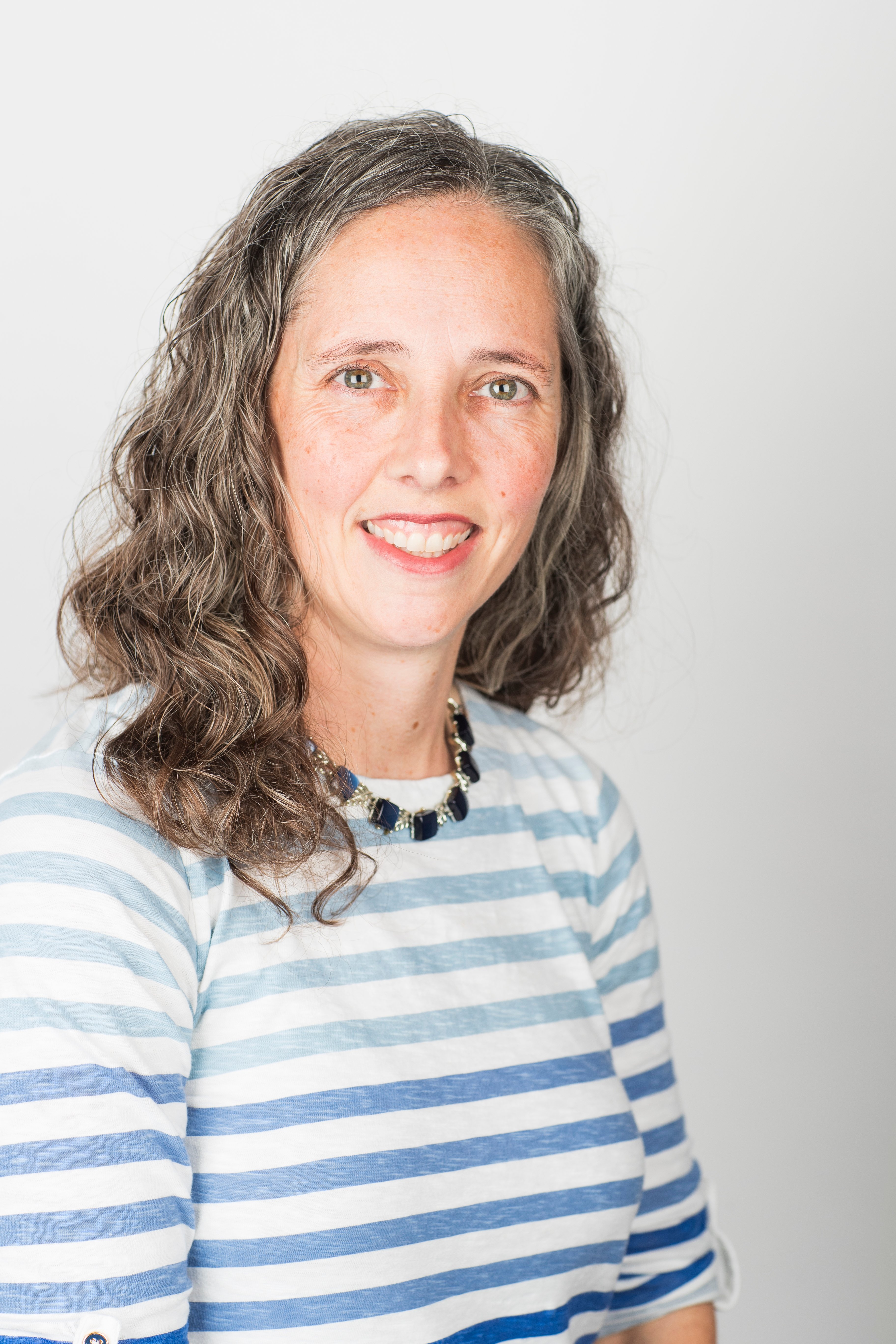 brunette female with a striped shirt on a white background