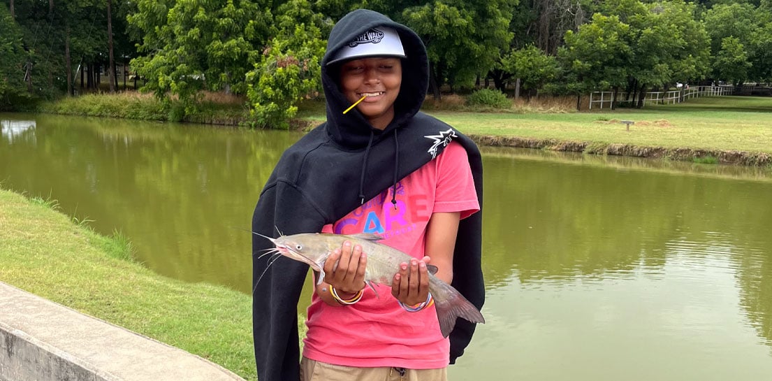 Girl holding catfish